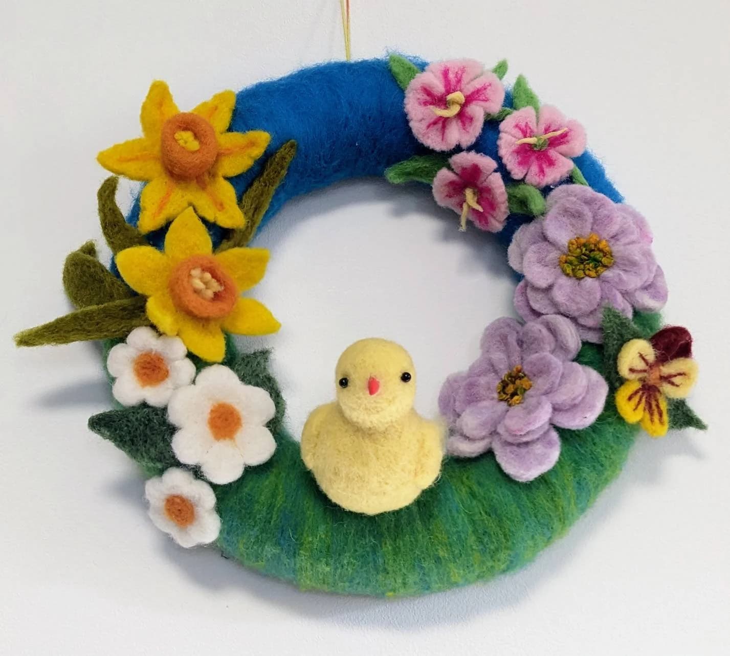 Beautiful Easter indoor wreath. Cute yellow baby chick in a floral ...