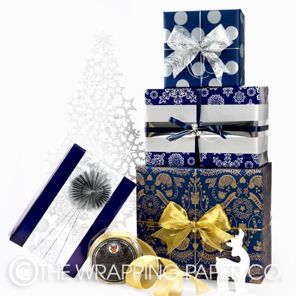 The Wrapping Paper Co. Christmas gift wrap. Left: Indigo Gloss with ...